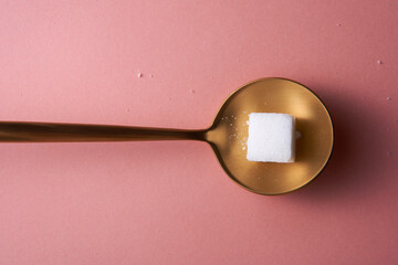 top view spoon of white sugar cubes