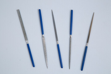 A set of small files for fine work on a white background.