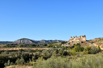 Village of Zorita de los Canes with its castle and mountains behind.