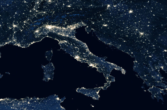 Earth at night, view of city lights showing human activity in Italy from space.  Elements of this image furnished by NASA.
