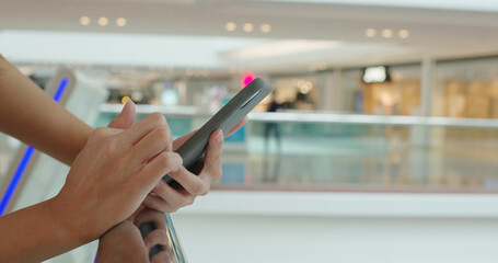 Woman use of mobile phone at shopping mall