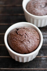 Chocolate fondant in the white ramekin  on the dark background. Lava cake.