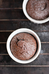 Chocolate fondant in the white ramekin  on the dark background. Lava cake.