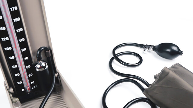 Blood Pressure Machine For The Patient Showing The Mercury Tube With Rubber Pipes On White Background.