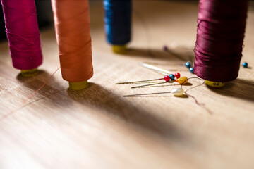 needle and colored threads for sewing