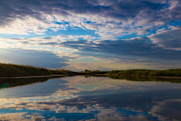 Silvery sunrise over a quiet lake.