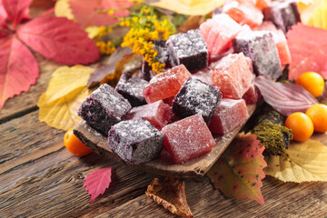 Solid homemade marmalade in an old wooden dish.