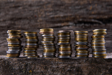 collection of colorful metal coins on wooden background, close view 