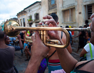 Men playing trumpet walking through the streets