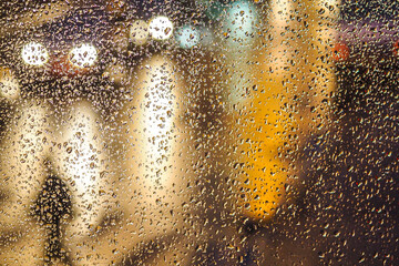 Rainy day, rain drops on window, rainy weather, rain and traffic lights bokeh, traffic jam, defocused