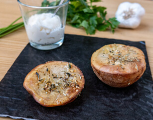 Baked potatoes, with herbs and acompanied with myonnaise sauce.