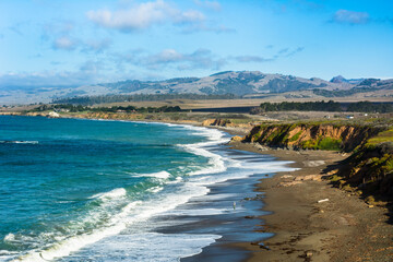 Man fishing in the waves on the central coast of California