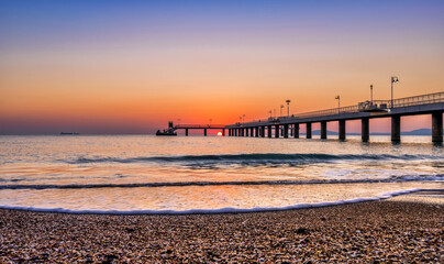 Fototapeta premium sunrise at the pier and the beach