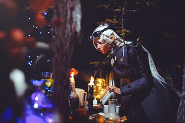 Halloween elf with magic magic in the dark forest.