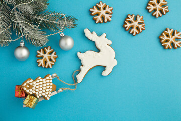 Christmas composition with gingerbread on the blue background with copy space