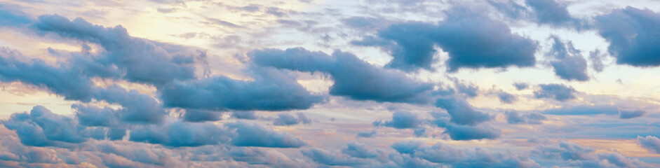 Beautiful row of blue clouds against sky at sunset. Cumulus clouds formation