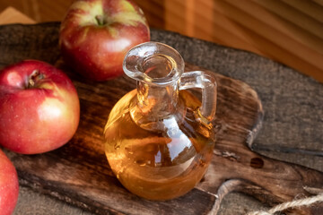 Apple cider vinegar in a bottle, with fresh apples