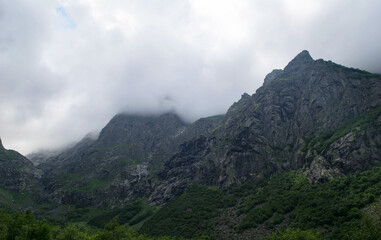 Fototapeta na wymiar View of the mountains of the North Caucasus. Mountains in the clouds in summer