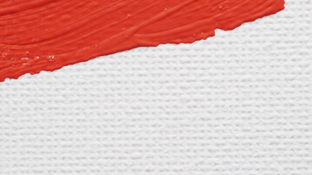 Red acrylic paint. Brush mix red color acrylic painting. Close up.