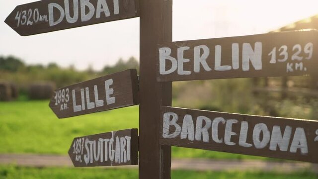 Old wooden road sign - Dubai, Berlin, Lille, Barcelona, Stuttgart