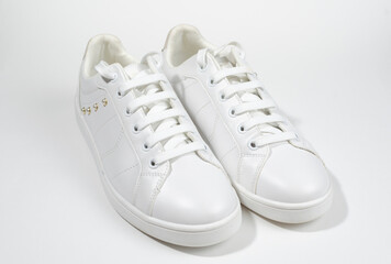 White sneakers on white background including edging