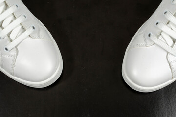 White sneakers isolated on black background.