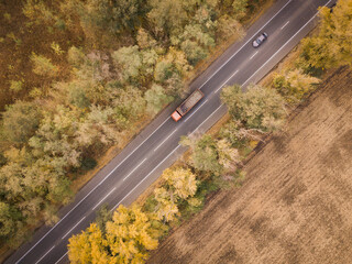 Green forest aerial drone view. Road with truck in forest from above. Transportation background. Rostov region. Russia.