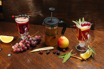 Various autumn or winter seasonal alcohol hot cocktails. Blueberry mulled wine, tea with pear and...