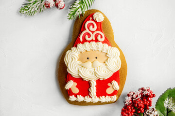 Gingerbread man Christmas cookies with hat beard and mustache of Santa Claus. Santa Claus with Christmas tree branches, top view. close up.