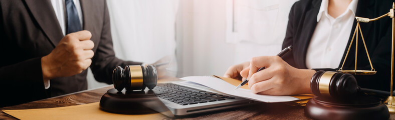 justice and law concept.Male judge in a courtroom on wooden table and Counselor or Male lawyer working in office. Legal law, advice and justice concept.