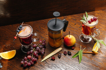 Various autumn or winter seasonal alcohol hot cocktails. Blueberry mulled wine, tea with pear and...