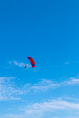 Parachutist is flying in the sky, sunny contrast image.
