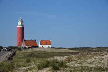 Fototapeta na wymiar View of the lighthouse on the island of Texel in the village of Cocksdorp.