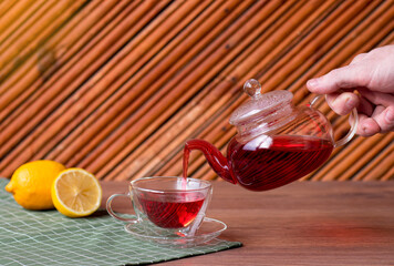 a man pours tea into a Cup