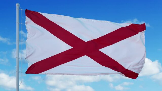 Alabama flag on a flagpole waving in the wind in the sky
