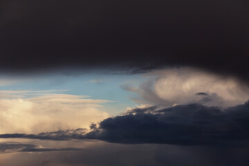 Fototapeta premium Epic dramatic Storm sky, dark grey and white big cumulus clouds on blue sky background texture 