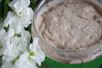 brown face mask on a background of flowers