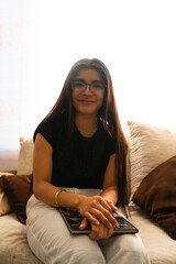woman with long hair sitting and with a book on her legs