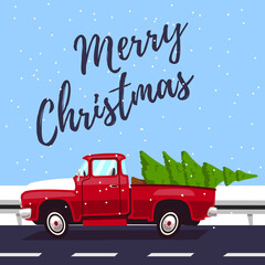 Red pickup truck with a Christmas tree in the trunk driving on the road.  Top inscription merry christmas.  Winter mood