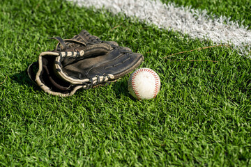 Baseball glove,  and ball on grass