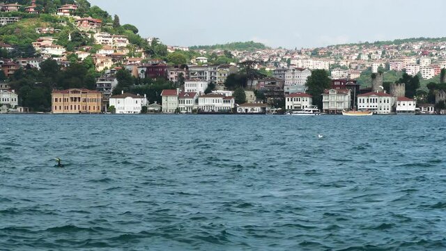 Beuatiful buildings (aka yali) and Anadolu Hisari (Castle) at the bank of Bosphorus, Istanbul, Turkey
