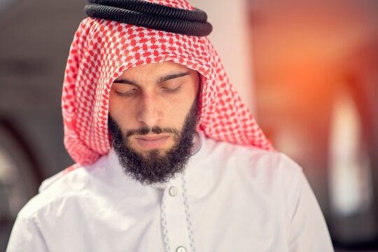 Religious arab muslim man reading holy quran