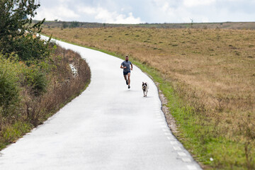 young man running on country road