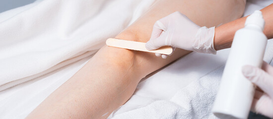 Obraz na płótnie Canvas Close up photo of woman leg preparing with wax before laser hair removal