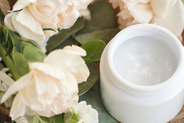 face cream, white, against flowers