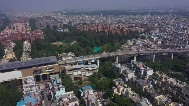 An aerial shot of the Delhi metro entering the station at Mayur Vihar, New Delhi, India