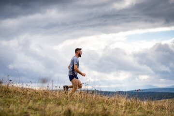 handsome trail runner running in nature