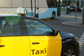 yellow taxi drive near  blue bus. Bus or taxi. City transportation and vehicle selection concept....