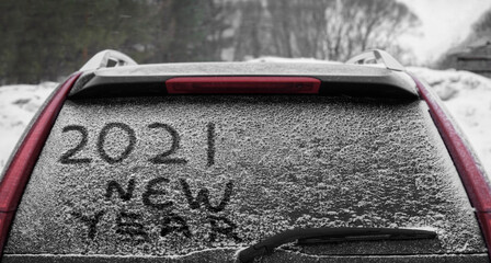Snow on the car where the numbers are written 2021.  back window of the car. 2021  happy new year