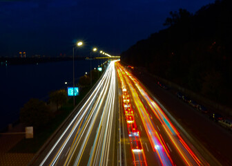 Fototapeta na wymiar Night flow of cars on the highway